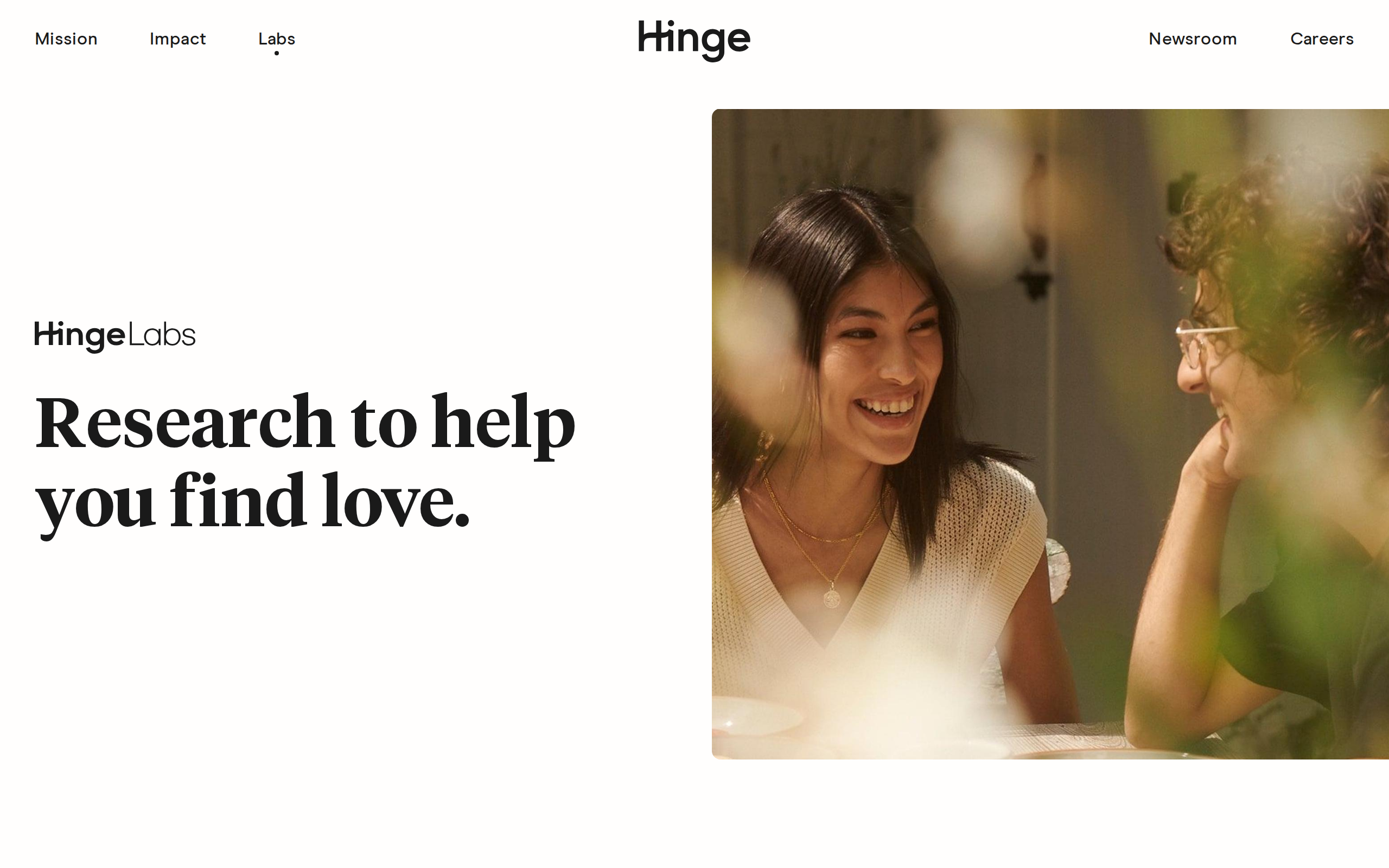 Hinge Labs page with the headline 'Research to help you find love' next to a photo of two people laughing across a dinner table.